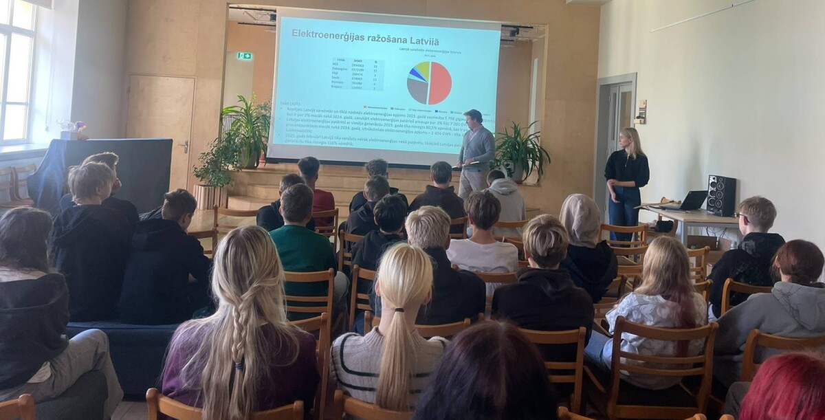 Vīrietis prezentē jauniešu grupai slaidu ar nosaukumu 